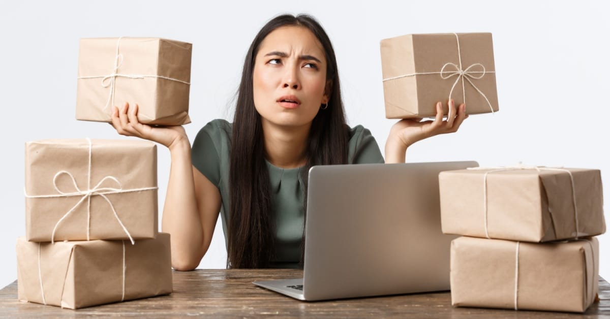 An Australian online seller looks uncertain while surrounded by parcels after courier Sendle abruptly shut down, leaving eBay shipments in limbo.